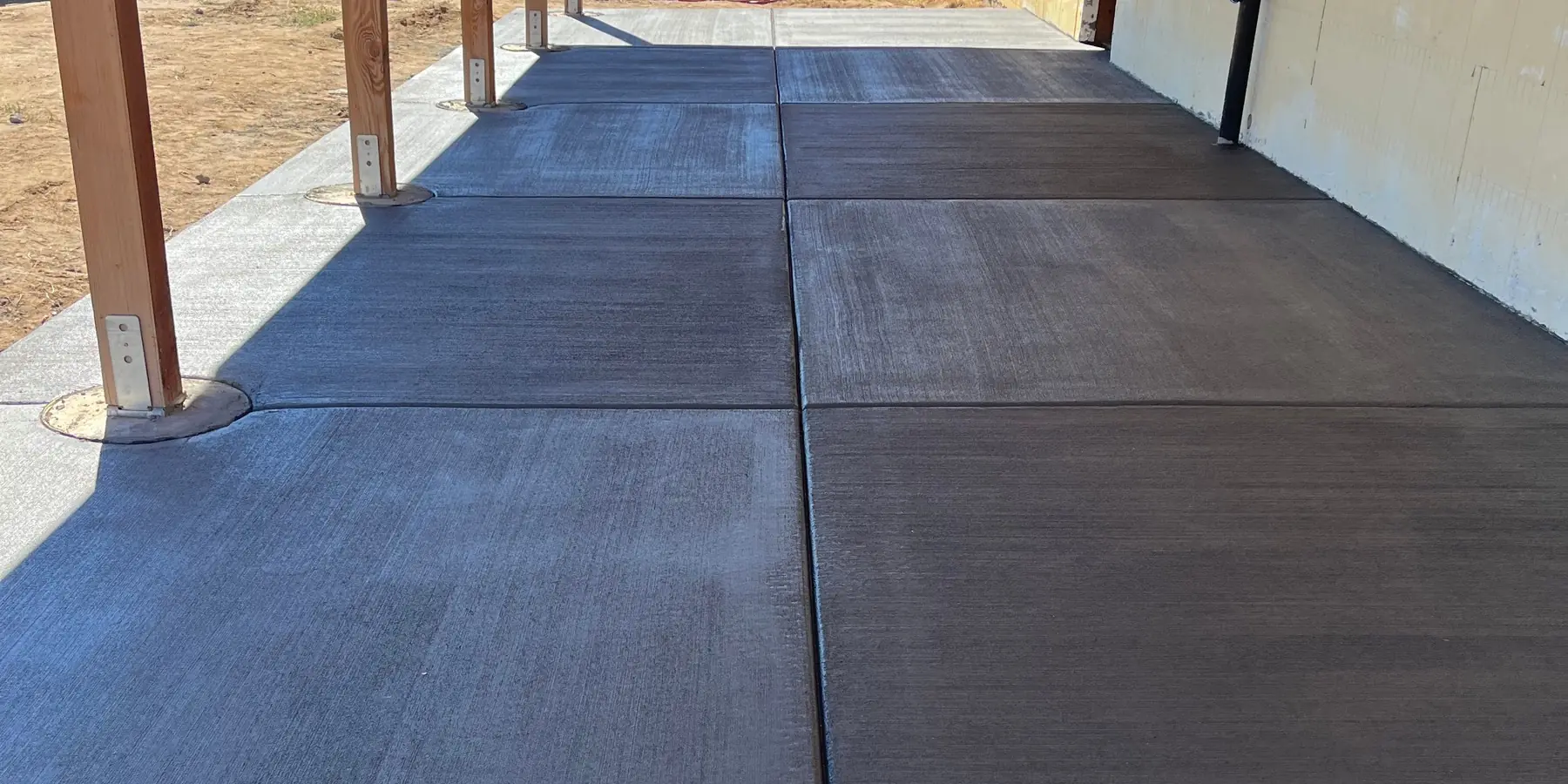 Long covered porch slab with control joints running toward the open plains