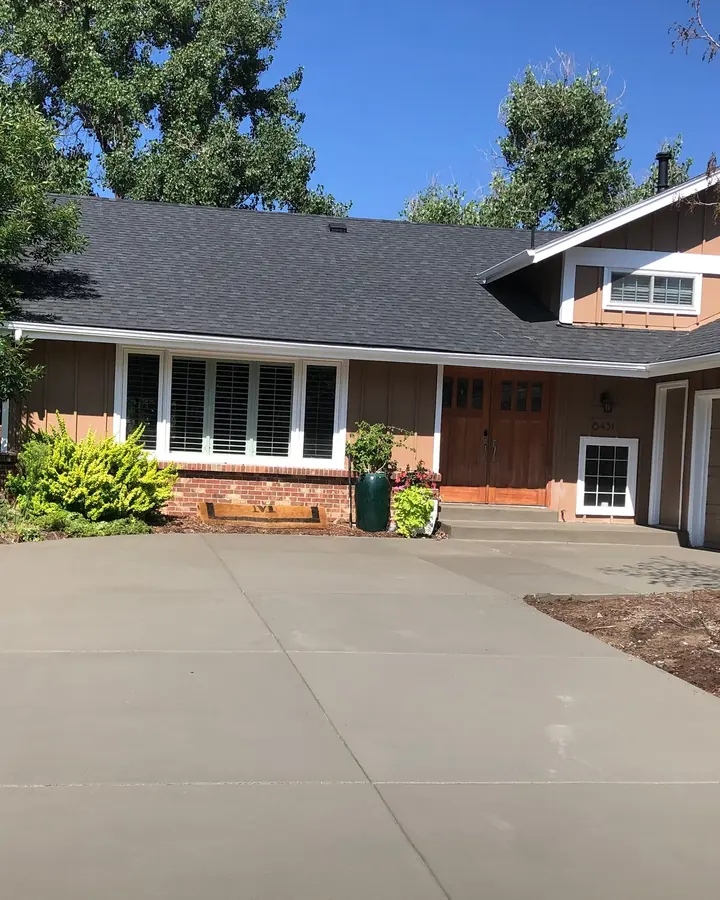 New broom-finished driveway in front of a ranch house