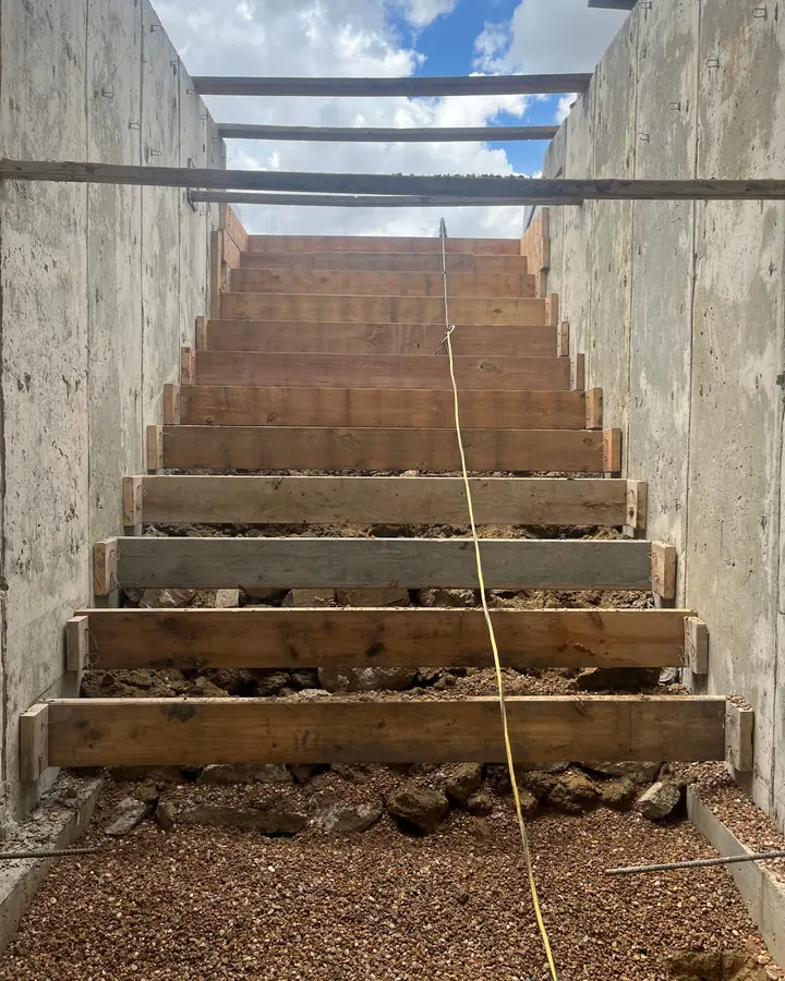 Basement egress stairs formed between concrete walls