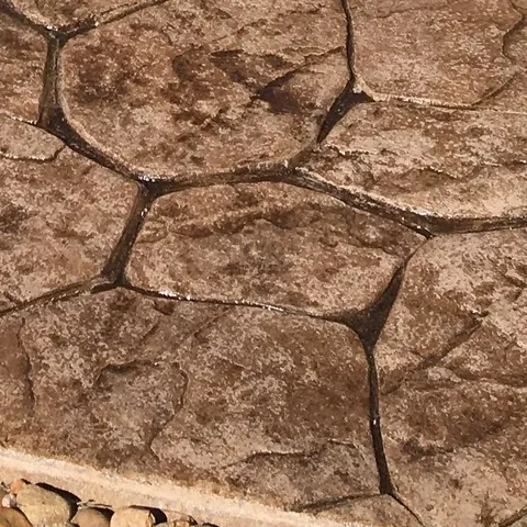 Close-up of flagstone-stamped concrete in a sandstone tone