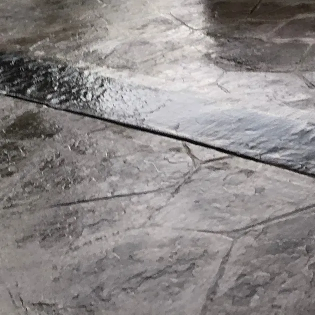Close-up of charcoal random-stone stamped concrete