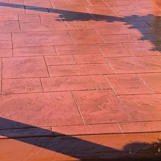 Close-up of terracotta-colored ashlar stamped concrete