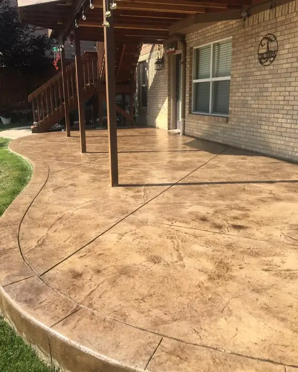 Tan stamped patio under a deck