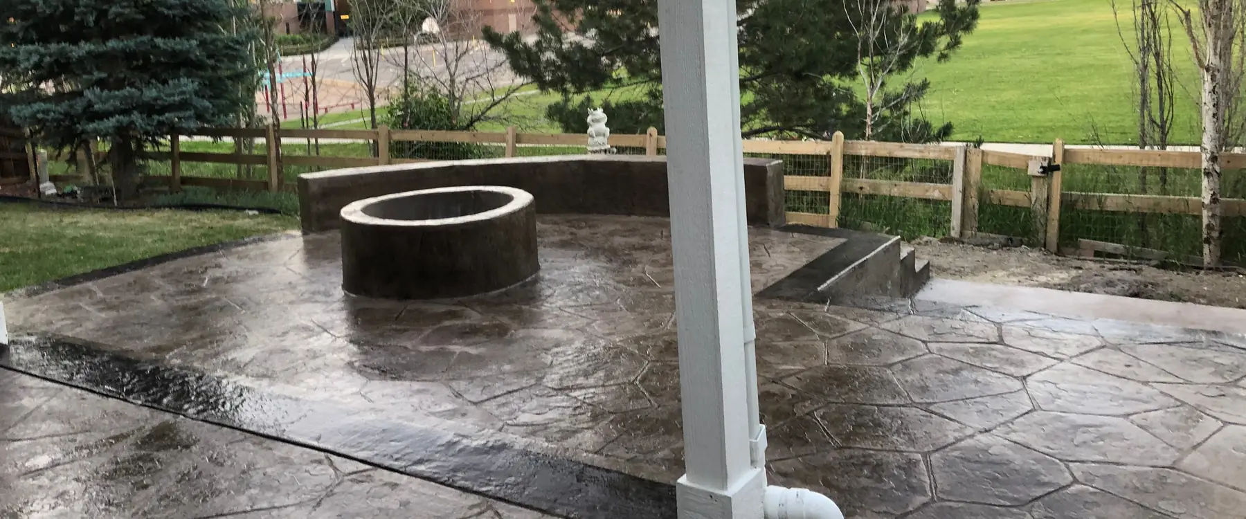 Charcoal stone-stamped patio with a built-in fire pit