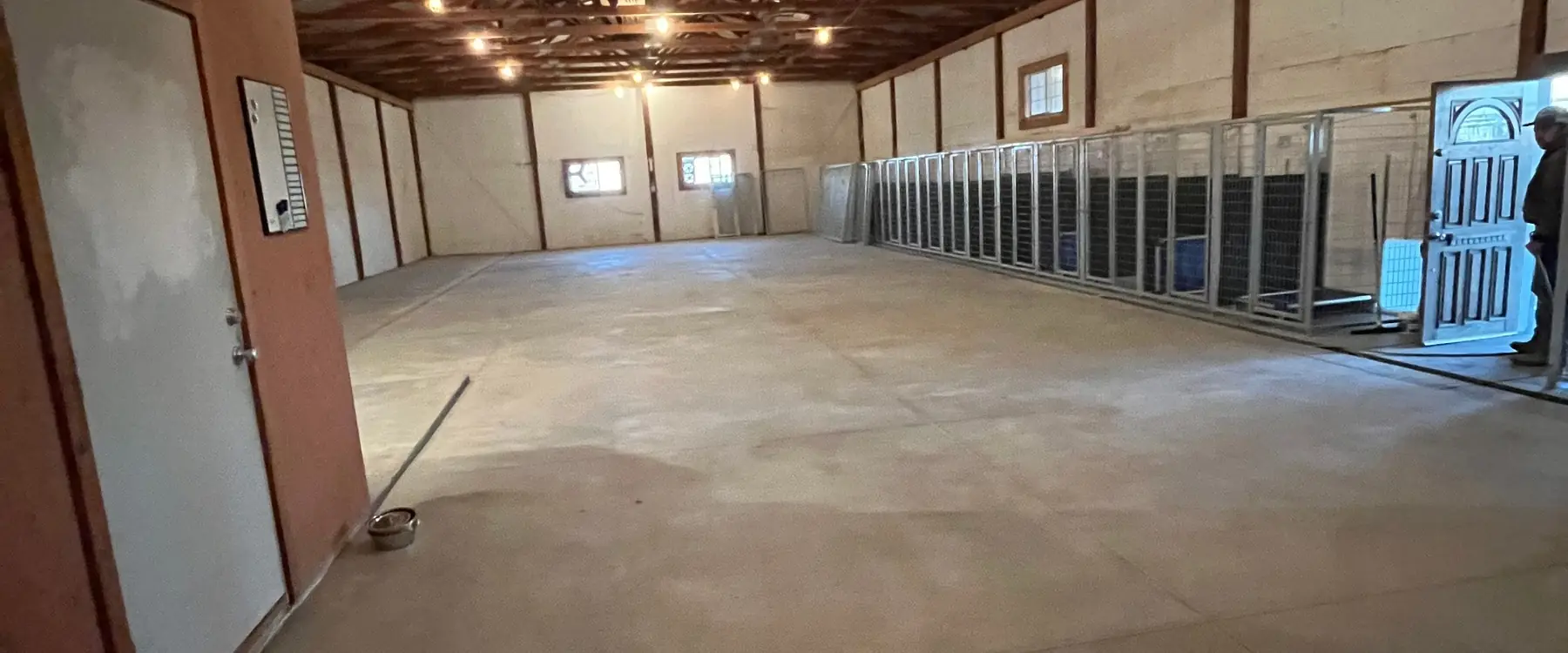 Smooth concrete floor inside a pole barn under timber trusses