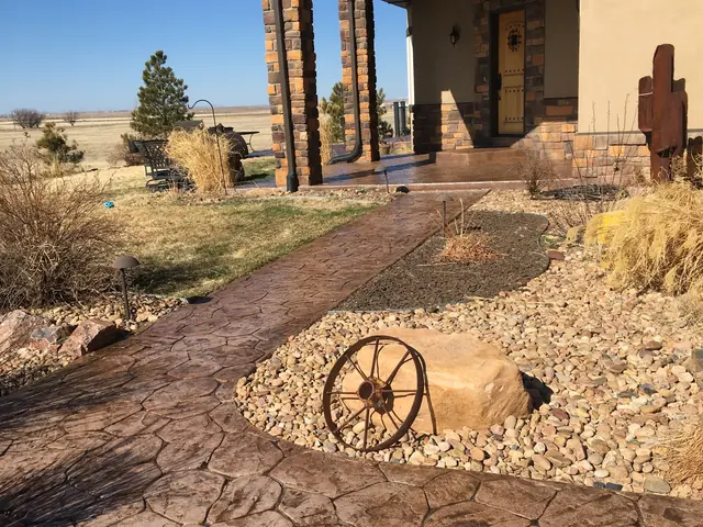 Flagstone-stamped front walk through rock landscaping